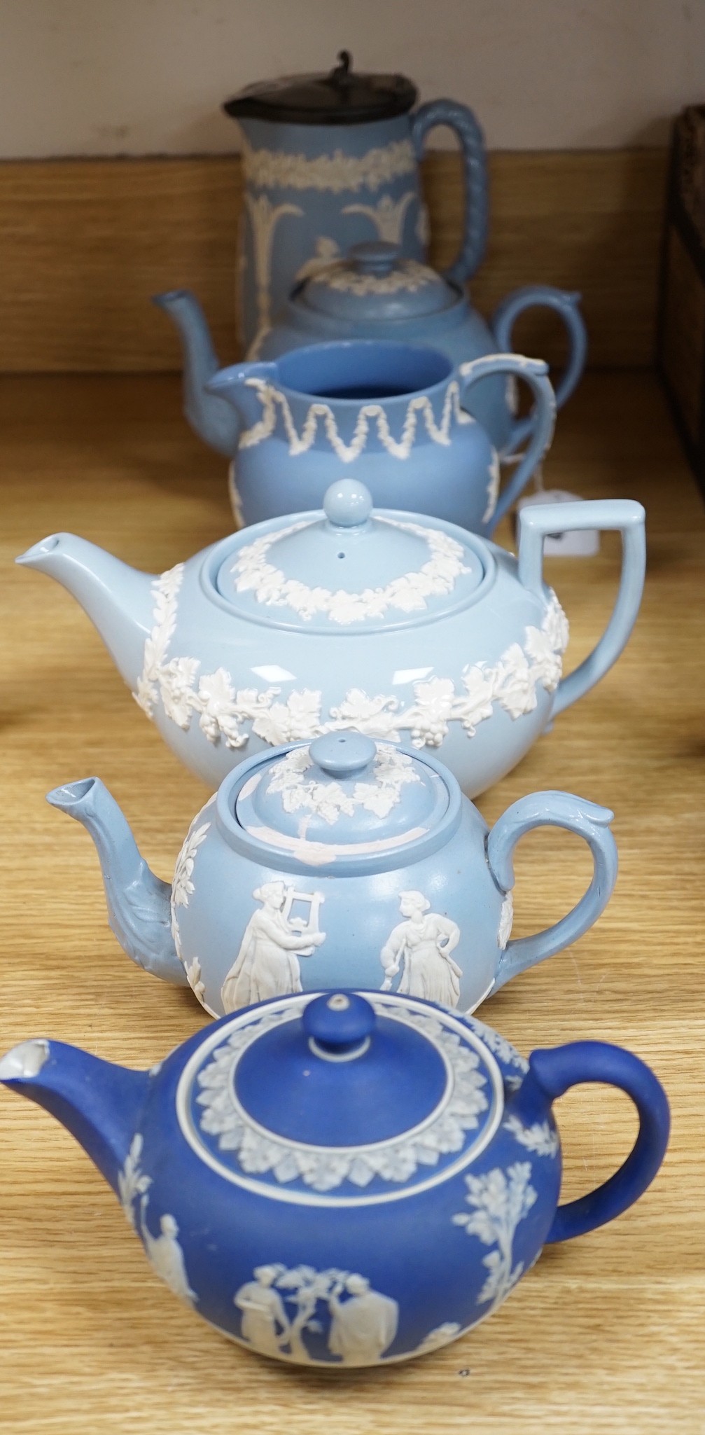 A group of Wedgwood and Wedgwood style jasperware teapots and jugs.
